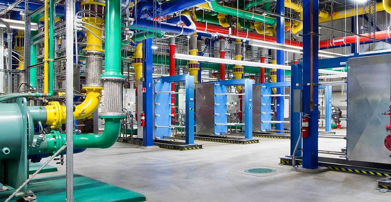 Energy transfer station ETS room with chilled water piping and mechanical equipment