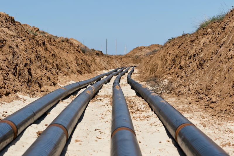Underground chilled water pipeline installation in excavated trench for district cooling network construction