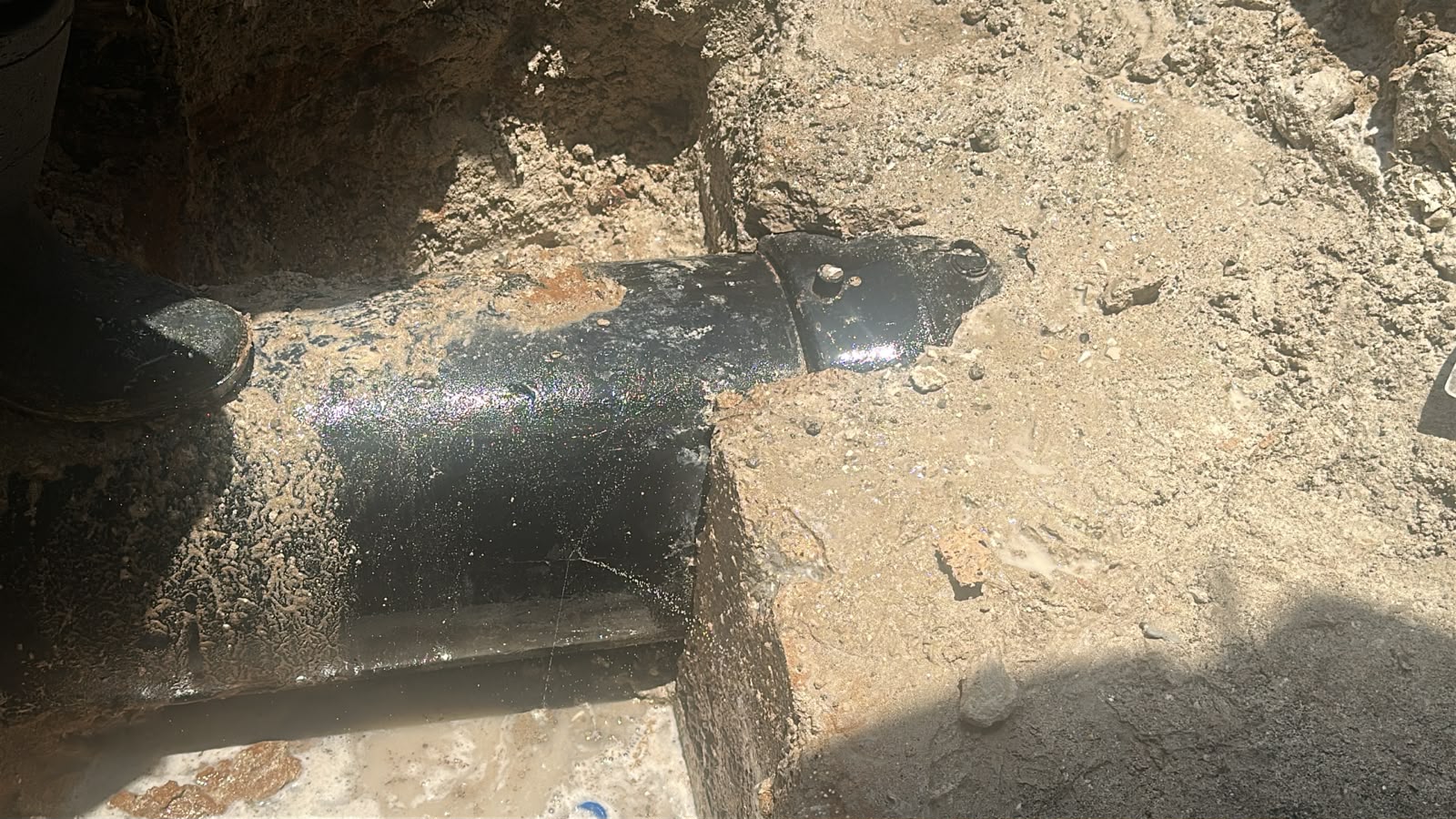 Exposed underground pipeline during leak repair work in Abu Dhabi
